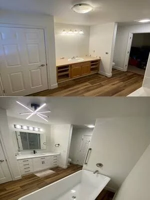 Bathroom remodel with wood-look vinyl plank flooring, white vanity cabinets, backlit mirror, and soaking tub
