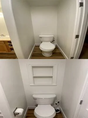 Small bathroom toilet alcove with white painted walls, recessed framed wall niche shelf, and white toilet on wood-look vinyl plank floor